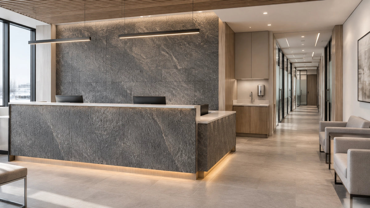 Contemporary medical reception lobby with a stone-textured feature wall and vertically finished reception desk
