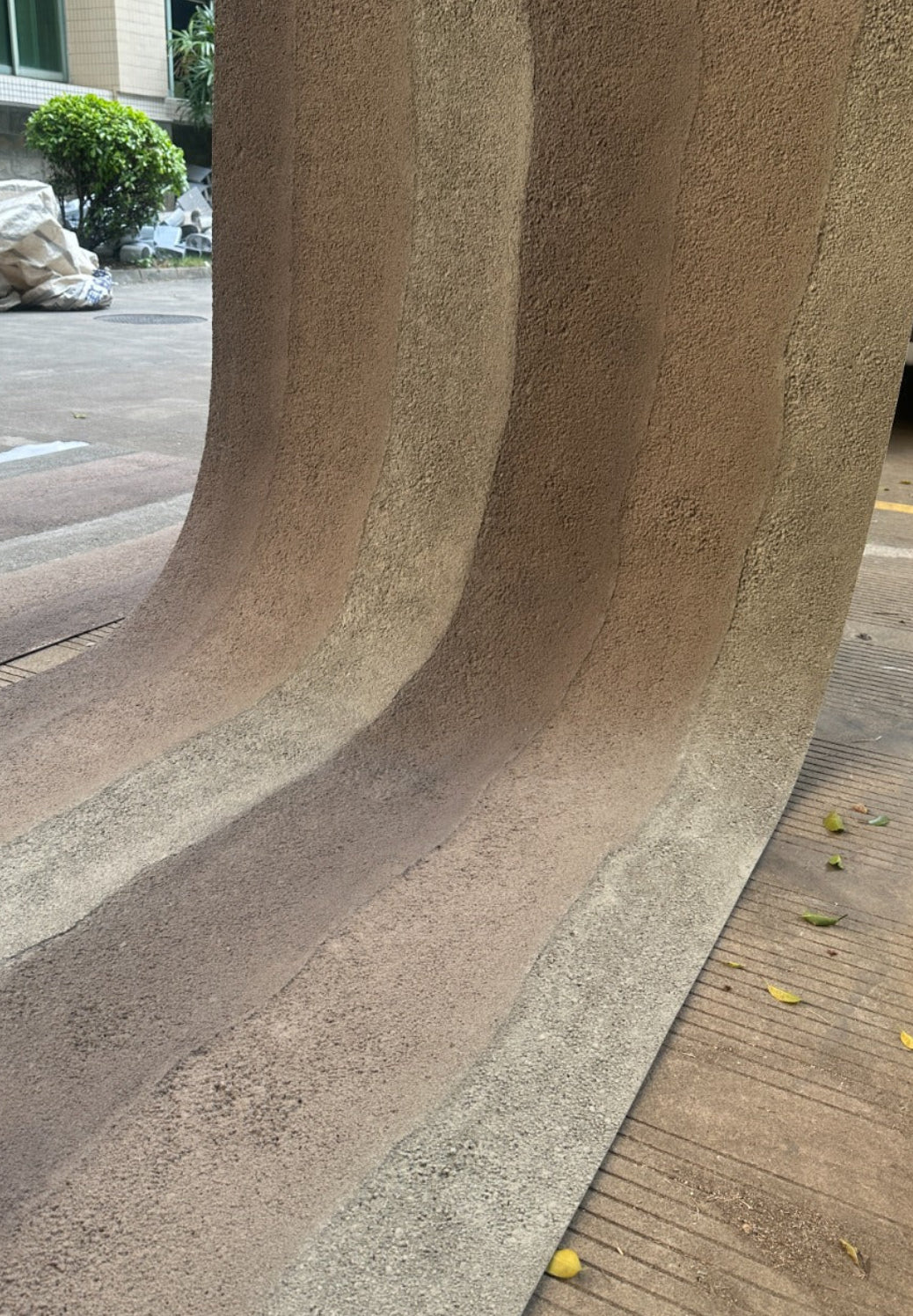 A large textured RE RELIC FLEXIBLEL NATURA STONE panel, likely a curved wall cladding sheet